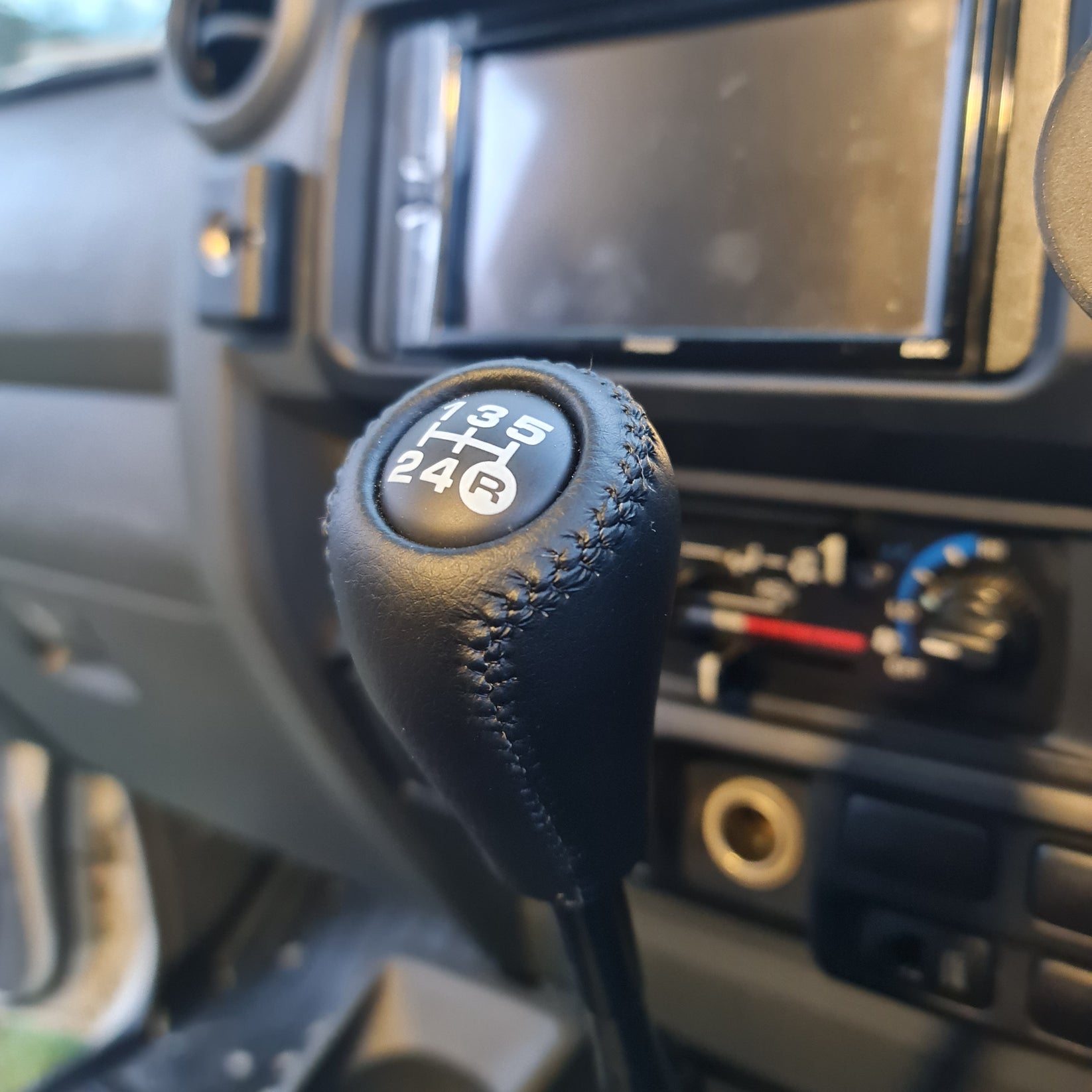 Car gear shift lever with numbers on a dashboard