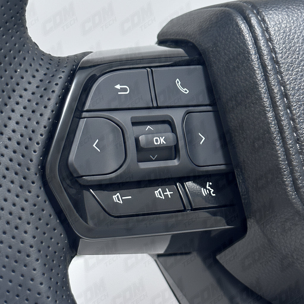 Steering wheel control buttons with various icons on a car steering wheel