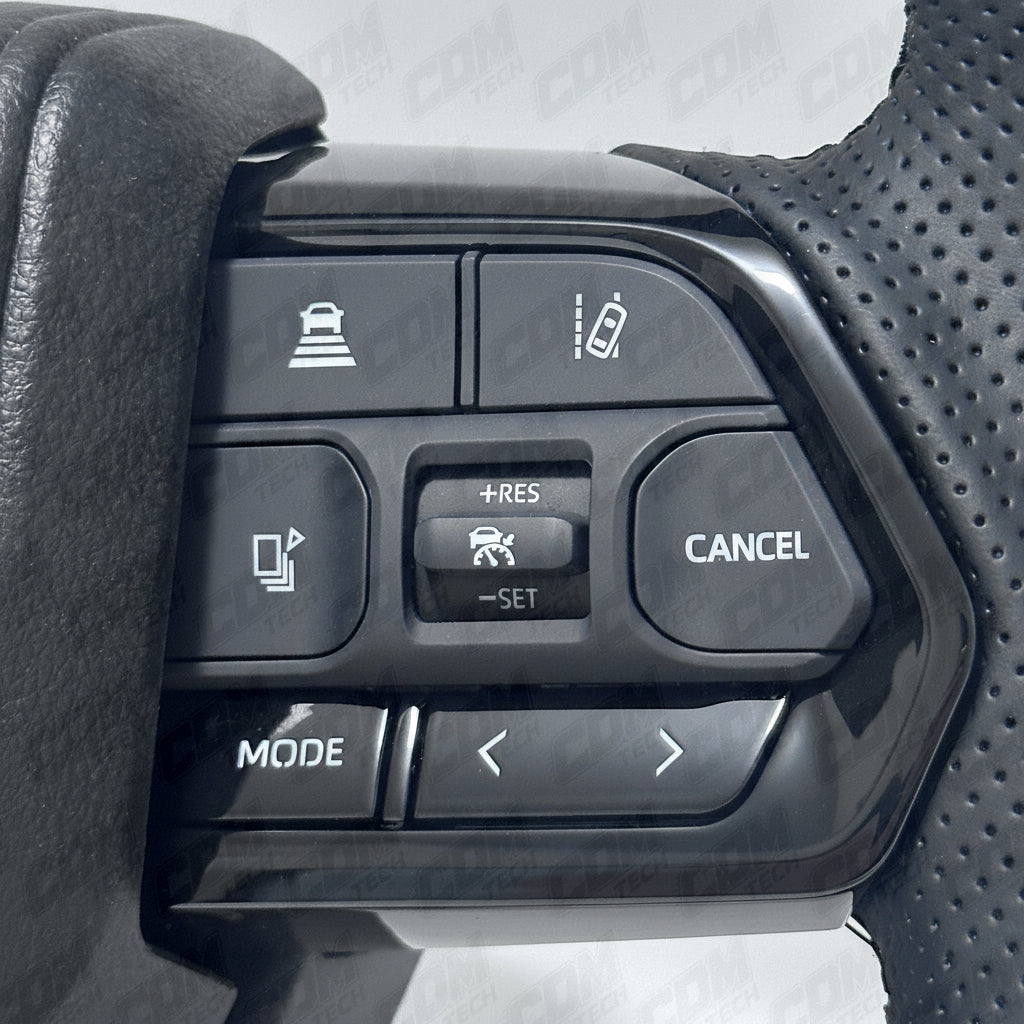 Car control panel with buttons labeled 'Mode', 'Cancel', and others on a textured gray background.